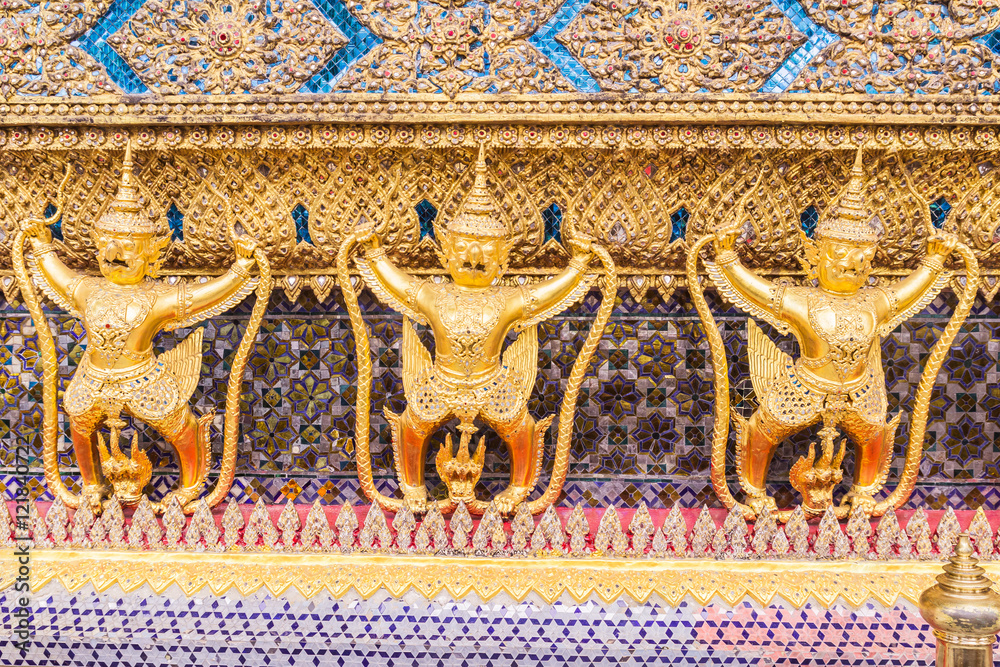 Fototapeta premium Golden garuda decoration on wall of main Buddhist church or 