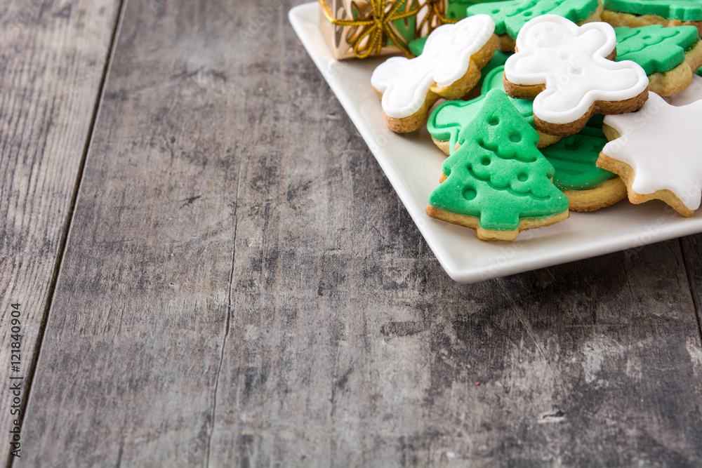 Christmas cookies on a plate and wooden table background
Christmas cookies on a plate and wooden table background