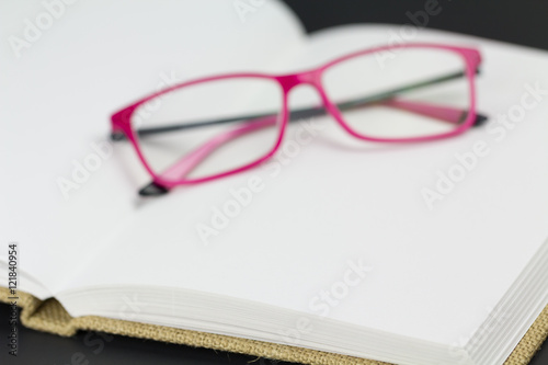 Eyeglasses resting on blank pages