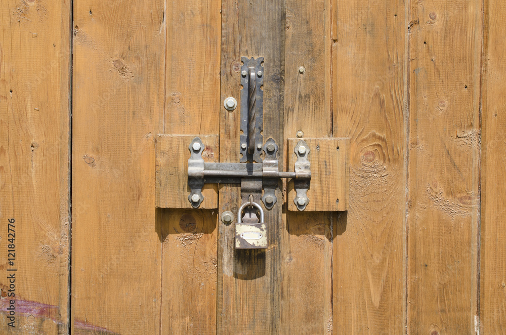 padlock on a wooden old door padlock on a wooden old door