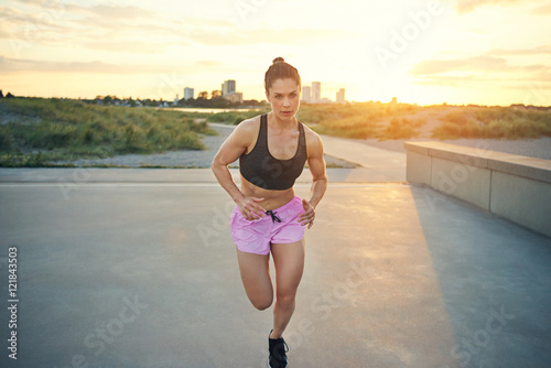 Attractive fit woman training in the early morning