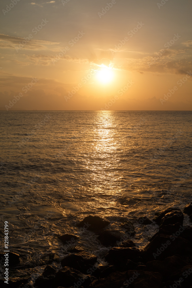 Fototapeta premium The sun rising over the sea