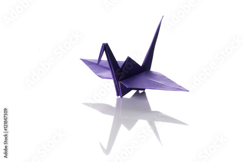 Origami art, colored crane isolated over a white background