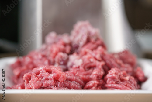 freshly minced beef with purple onion on kitchen table