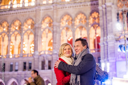 Photography Senior couple walking in night city. Winter, Historical building