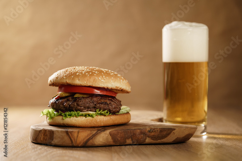fresh homemade burger with beer on olive board