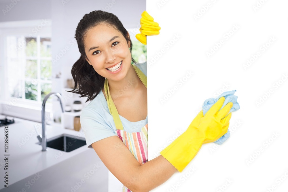 Composite image of cheerful woman cleaning white surface Composite image of cheerful woman cleaning white surface