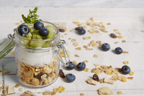fresh breackfast with cereals yogurt blueberry and kiwi photo