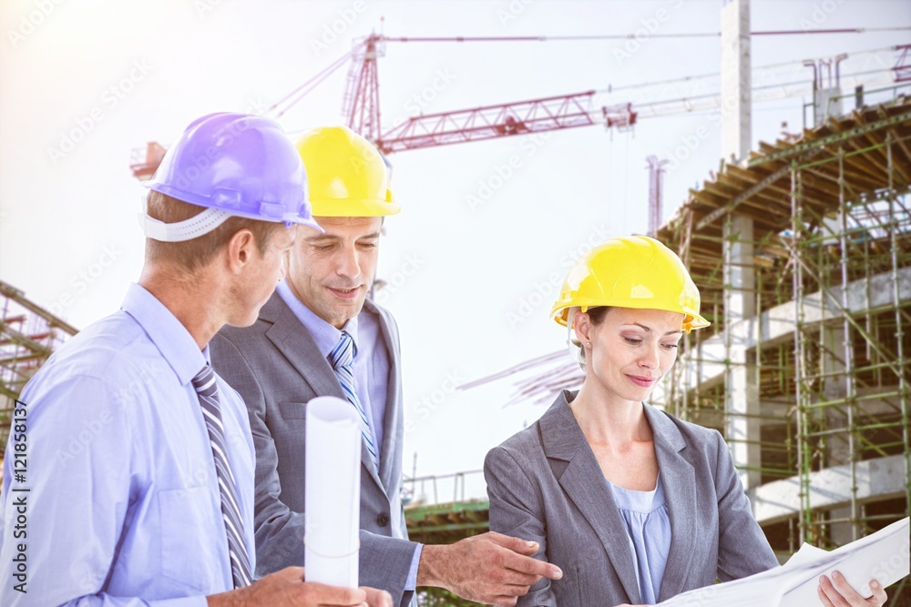 Businessman explaining a blueprint to his team Businessman explaining a blueprint to his team