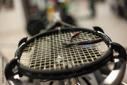 Racket stringing. Detail of tennis racket in the stringing machine © guruXOX