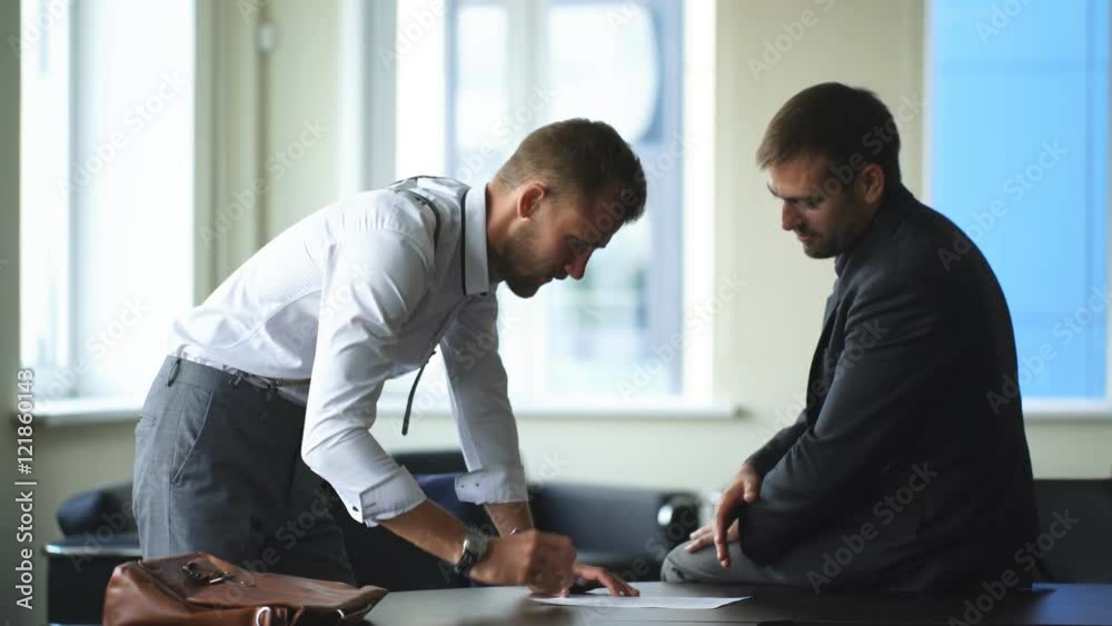 two businessmen signed an important contract at the office two businessmen signed an important contract at the office