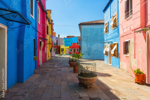 Exterior of colorful houses of Burano Island in Venice.Windows,walls,laundries,flowers and even umbrellas reflects the culture of the people in the island.