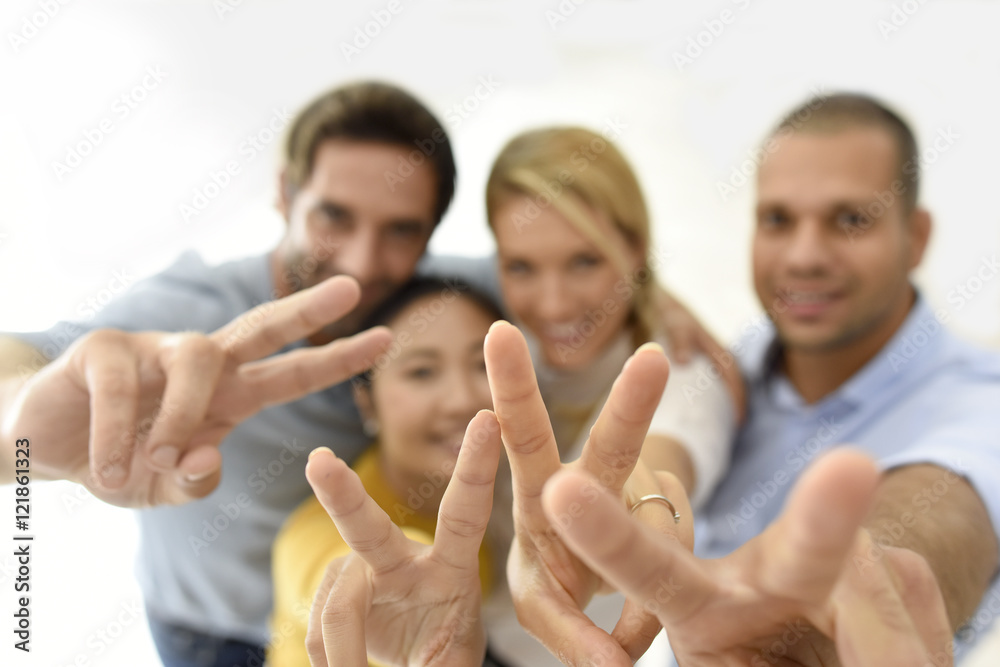 Group of people showing thumbs up to camera Group of people showing thumbs up to camera