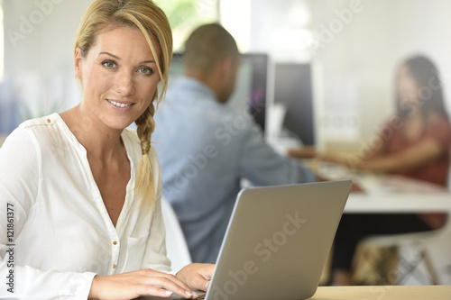 Blond businesswoman working in office