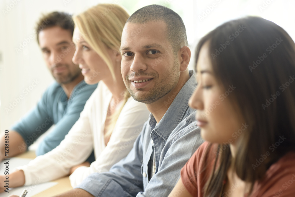 Smiling hispanic businessman attending meeting Smiling hispanic businessman attending meeting