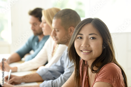 Beautiful ethnic woman attending business meeting