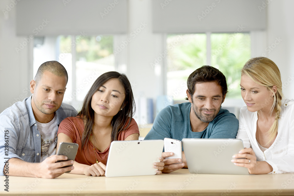 Start-up business people meeting with tablets and smartphones Start-up business people meeting with tablets and smartphones