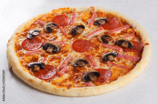 pizza ham mushrooms pepperoni close-up side view isolated