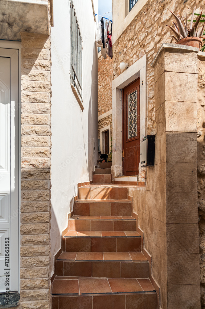 Stairs between traditional greek houses at narrow street of Sitia town on Crete island
