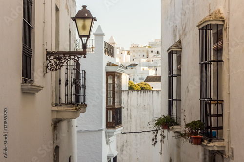 Typical narrow street of a white Andalusian village (Spain)