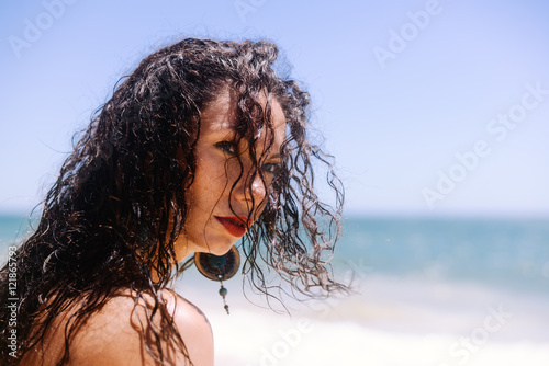 Beautiful woman in bikini on the sunny beach outdoors background