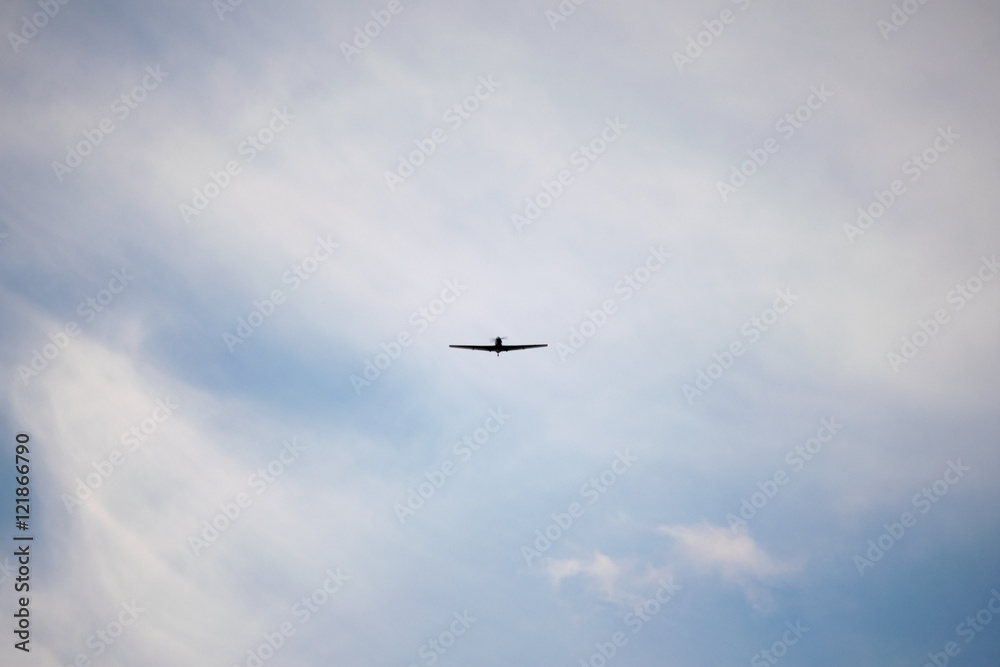 Zlin Z-526F acrobatic airplane flying on cloudy sky Zlin Z-526F acrobatic airplane flying on cloudy sky