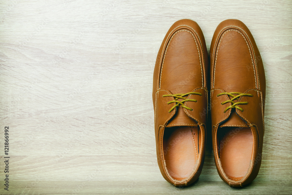 Fototapeta premium Brown Leather shoe on wood table background