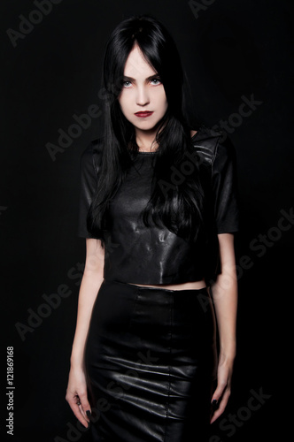 Gorgeous brunette with white skin, red lips on black backdrop