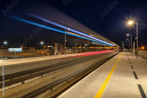 Night view. Train departing from railway station platform with motion blur effect. © vivoo