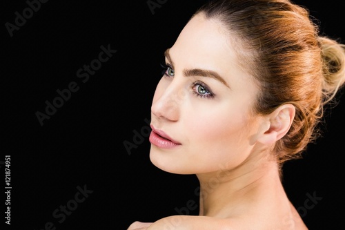 Beautiful woman posing against black background