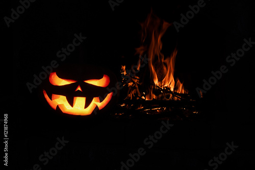 Halloween Scary Pumpkin fireplace with fire, isolated in the dar