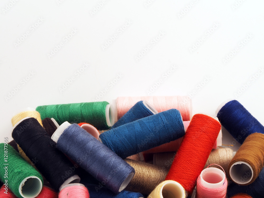 colored spools of thread on white colored spools of thread on white