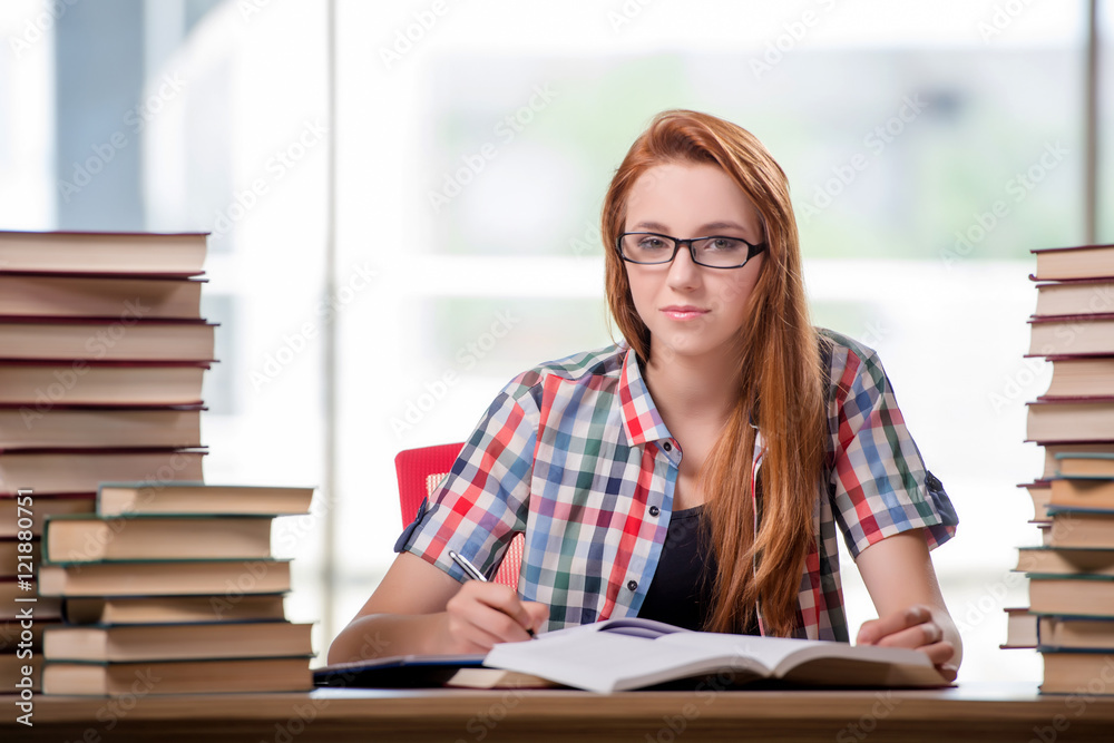 Student with stacks of books preparing for exams Student with stacks of books preparing for exams