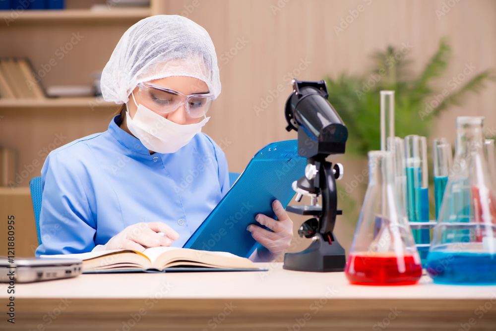 Lab chemist working with microscope and tubes Lab chemist working with microscope and tubes