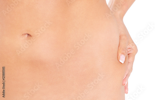 Slim woman pinch skin on hip