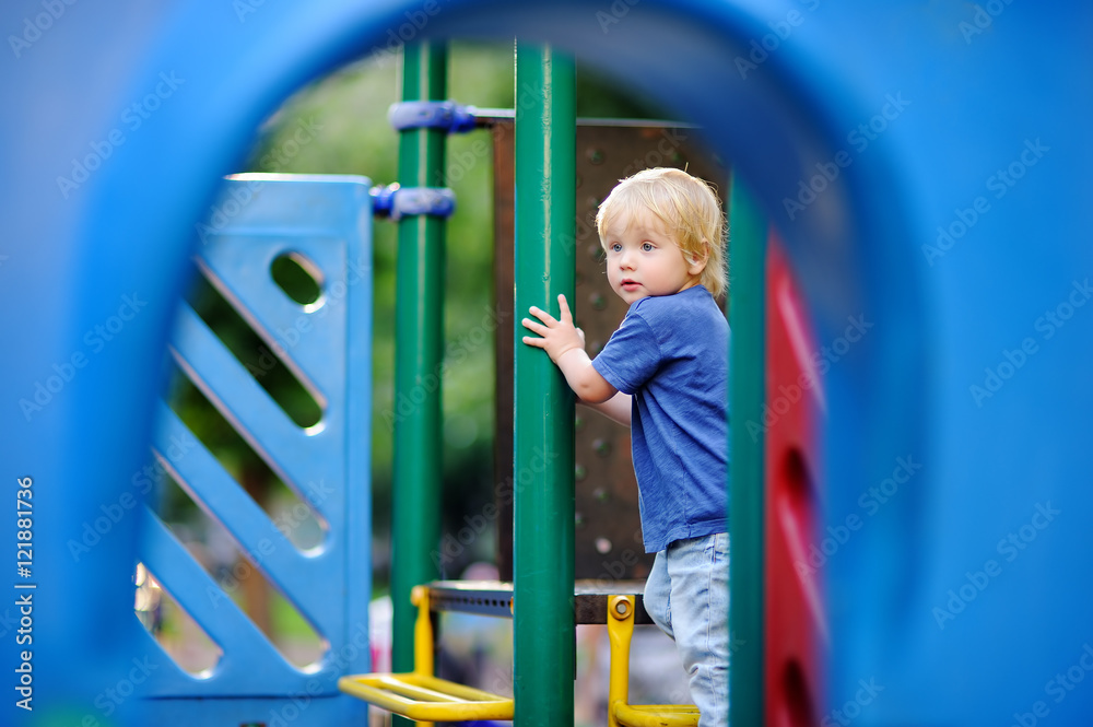 Cute toddler boy having fun on outdoors playground Cute toddler boy having fun on outdoors playground