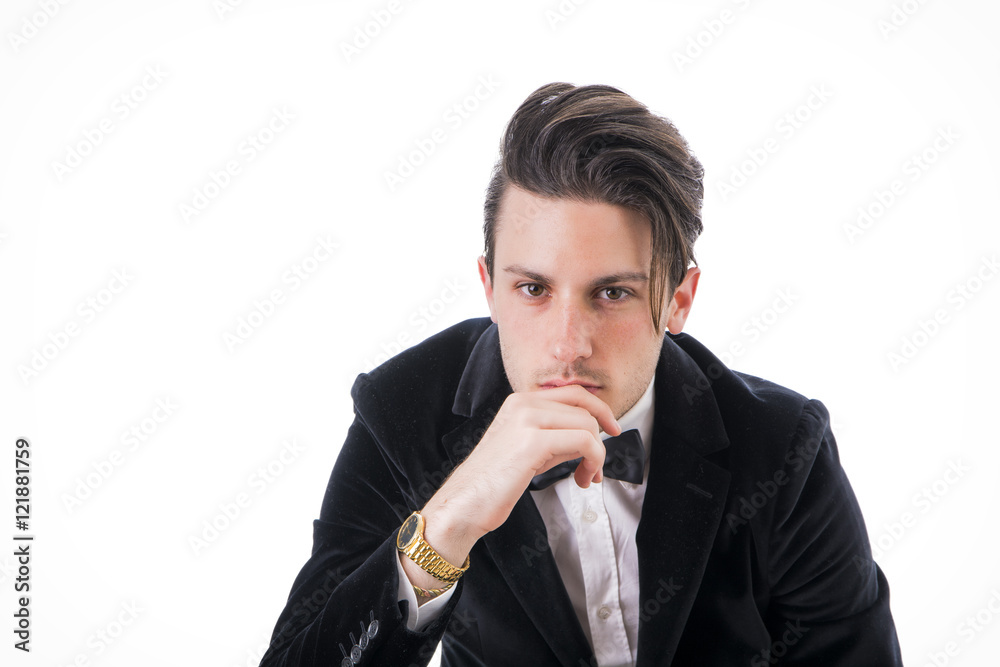 Young businessman confidently posing and looking to a side, wearing suit isolated in white background Young businessman confidently posing and looking to a side, wearing suit isolated in white background