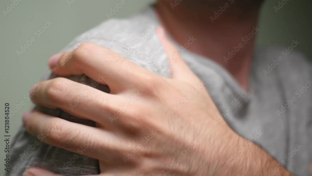 rubbing his shoulder because of the pain rubbing his shoulder because of the pain