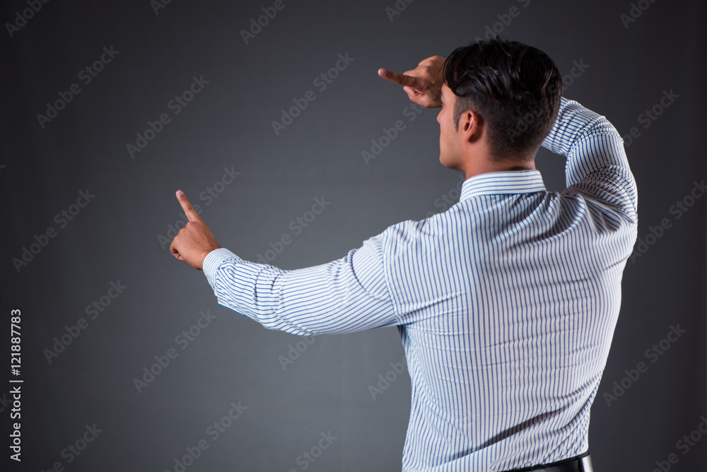 Handsome businessman pressing virtual buttons Handsome businessman pressing virtual buttons