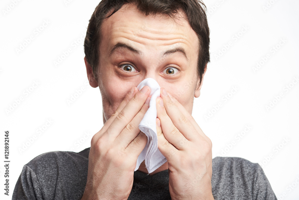 young man blowing his nose young man blowing his nose