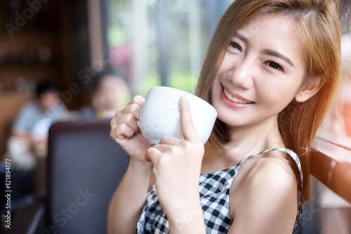 Portrait of young beautiful woman sitting in a cafe