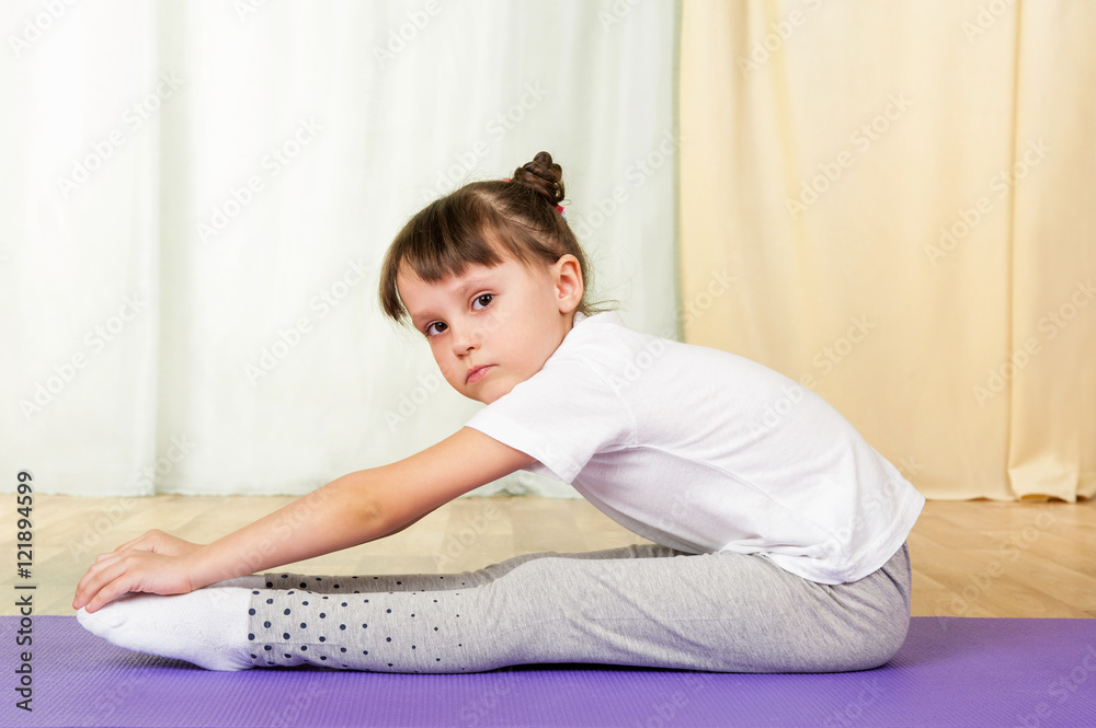 Tired little girl doing fitness exercises Tired little girl doing fitness exercises