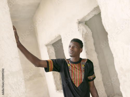 Quadro em tela Young man standing in an unfinished building