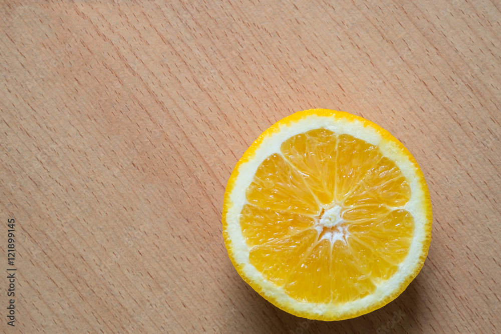 Slice fresh orange on wooden background. Top view. Slice fresh orange on wooden background. Top view.