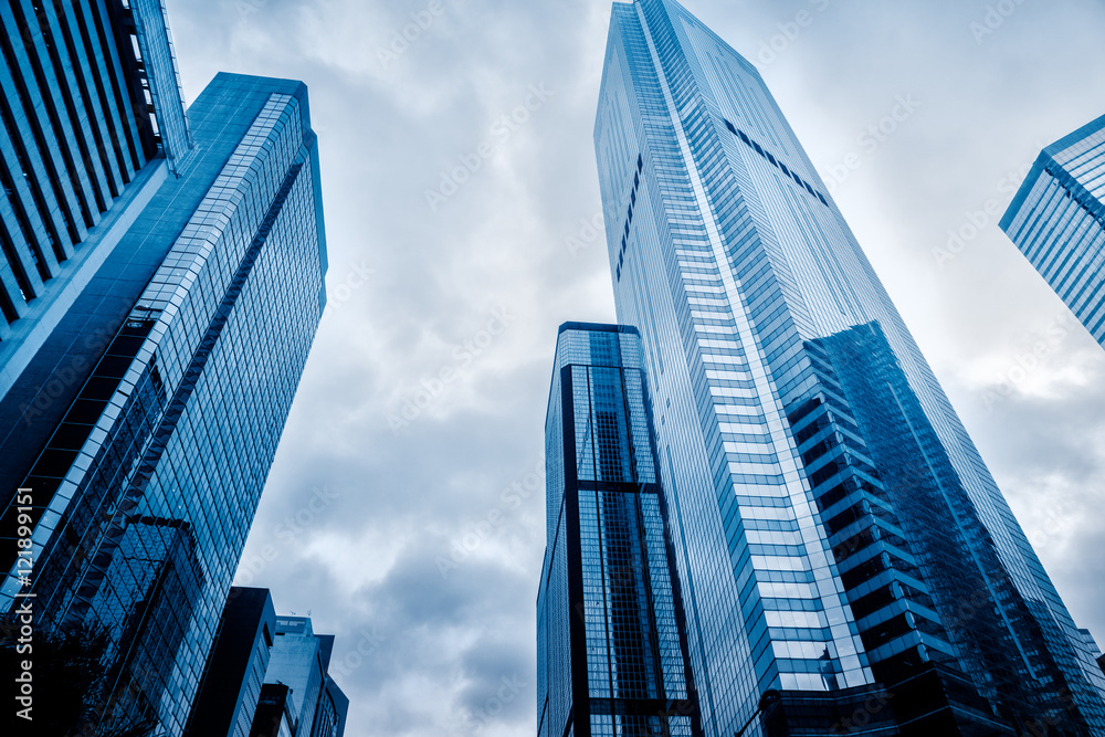 low angle view of modern metallic skyscrapers,blue toned,suzhou,china. low angle view of modern metallic skyscrapers,blue toned,suzhou,china.