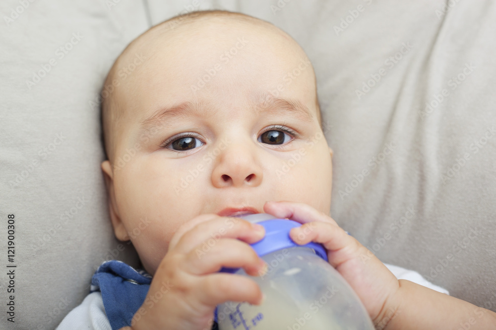 Baby boy drinking milk from the bottle Baby boy drinking milk from the bottle