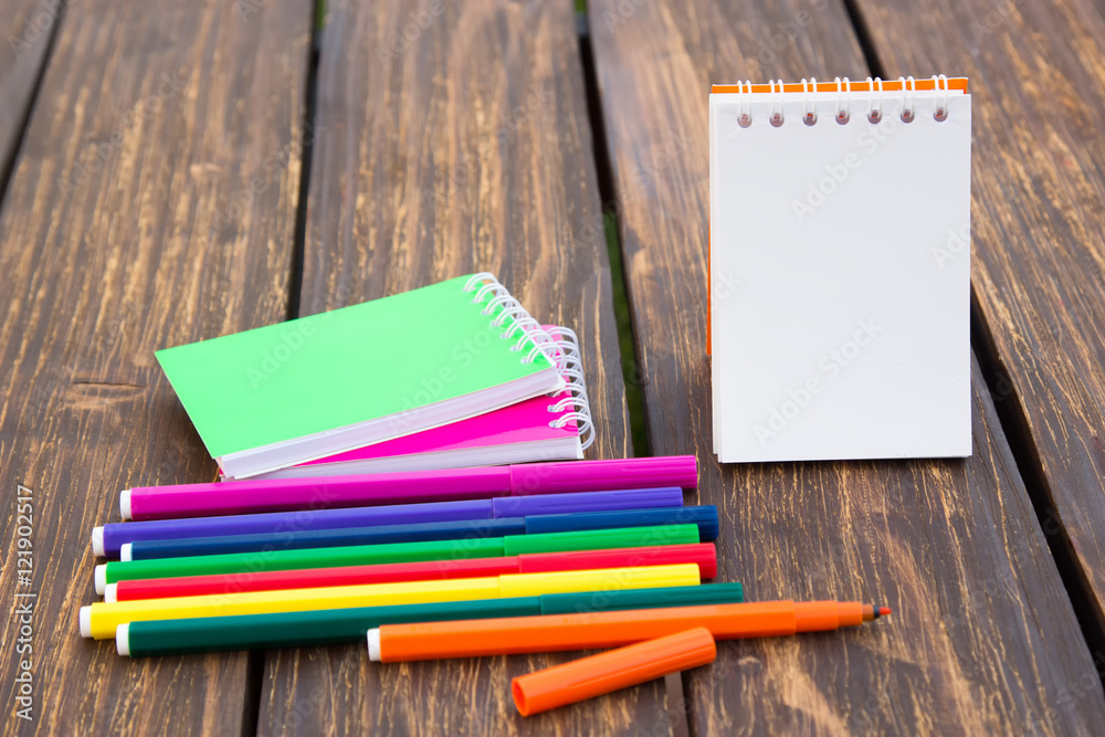 Felt-tip pen and notepad on a wooden background Felt-tip pen and notepad on a wooden background