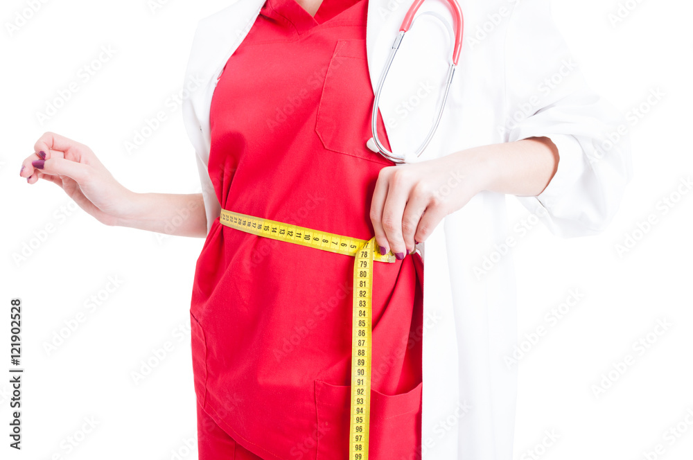 Closeup of female doctor measuring her waist