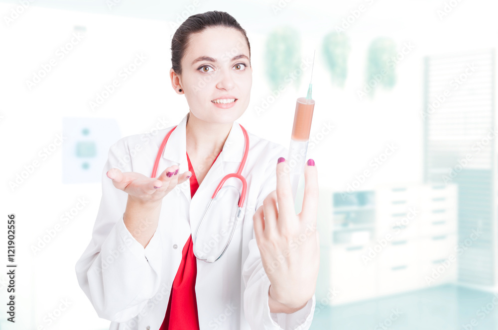 Smiling female doctor holding syringe