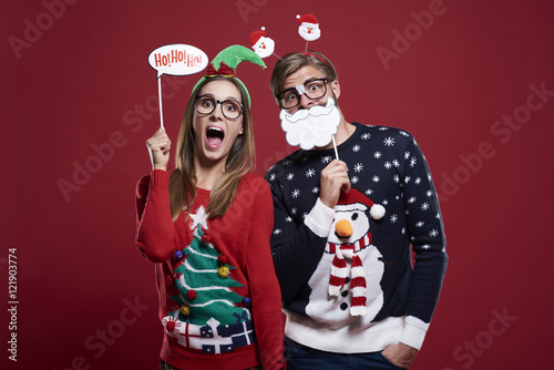 Couple with funny christmas masks. © gpointstudio
